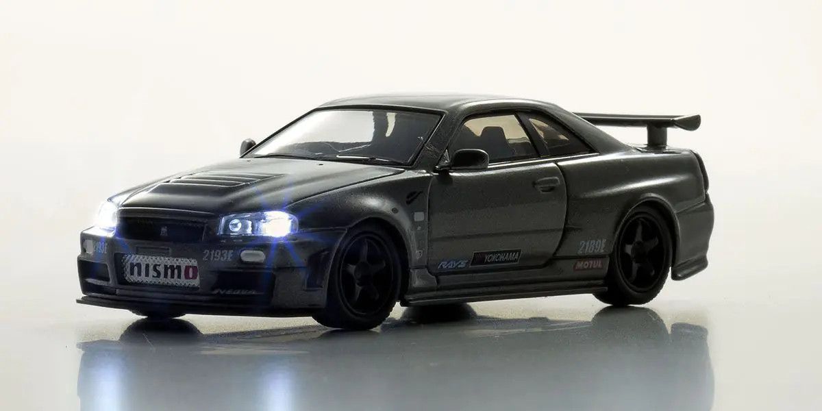 Kyosho - [MOTN] Nissan Skyline R34 GT-R NISMO CRS Ver. with LED (Gray), escala 1:64